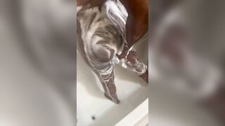 Ebony scrubbing her DDD tits and big ass