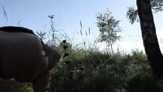 Piss in a public garden. Mature milf exposes big tits, shakes her fat ass outdoors. Hairy pussy urinates. Exhibitionism.