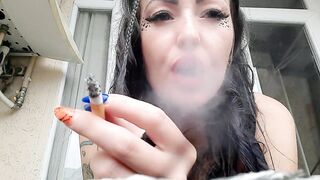 Dominatrix Nika smokes a cigarette and blows smoke in your face. Smoking fetish. The fetish of cigarette smoke.