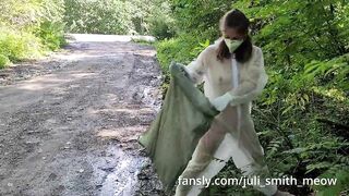 Girl in transparent overalls clean up trash in public