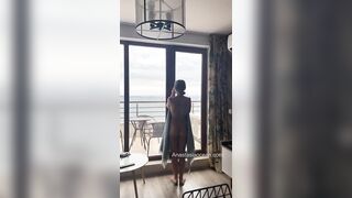 Sexy slender girl flashes her natural bare breasts on her balcony.