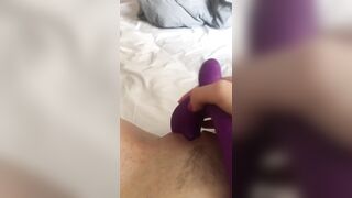 Masturbates her pink pussy with a vibrator and caresses with her fingers.