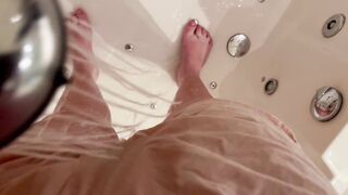 Girl using shower after wetting accident in shorts