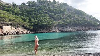 girl swimming on a public beach completely naked