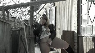 A mature fat milf smokes and shows her tits and pussy in the courtyard of an abandoned house.