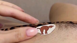 Tattoo master in leopard panty doing temporary tattoo