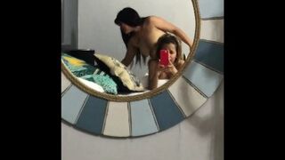 I film myself in front of the mirror while my girlfriend fucks my pussy on all fours with her strap-