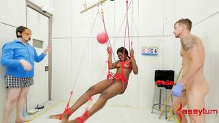 Bound ebony submissive hanging from ceiling